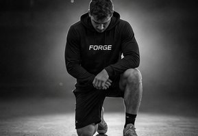 A man kneeling in stillness, head bowed, before the work begins